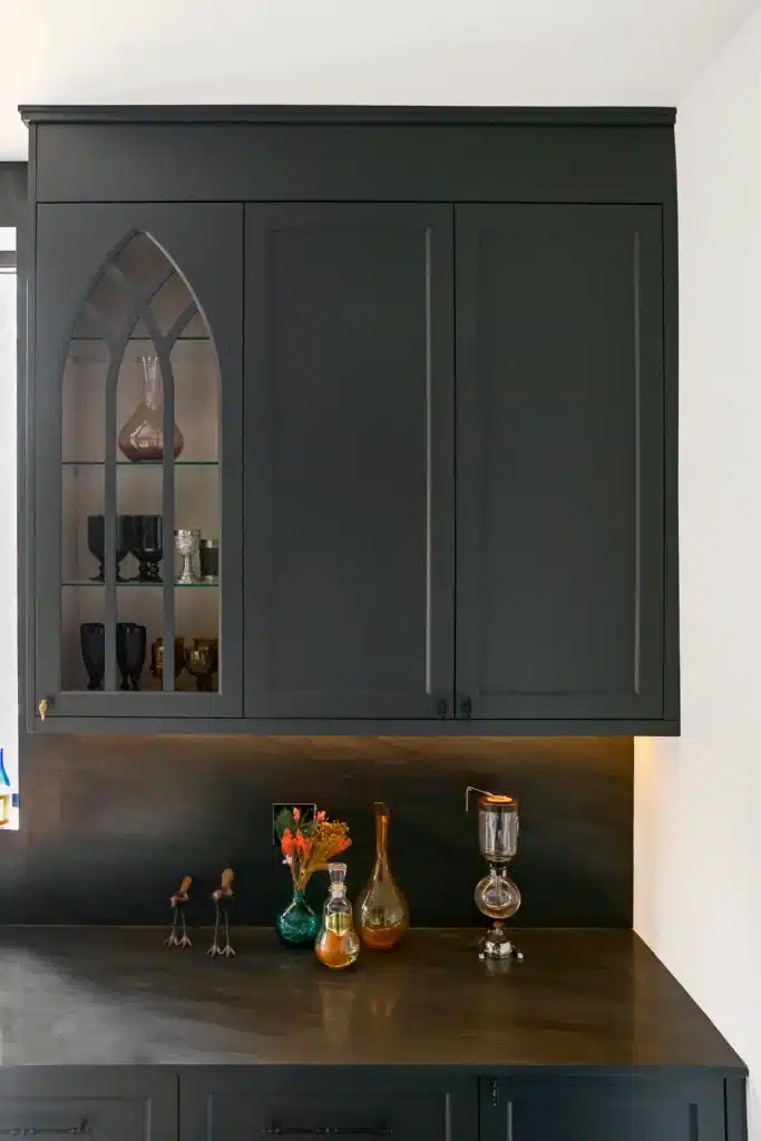Victorian kitchen renovation in Toronto with dark custom cabinetry, farmhouse sink, and brass fixtures