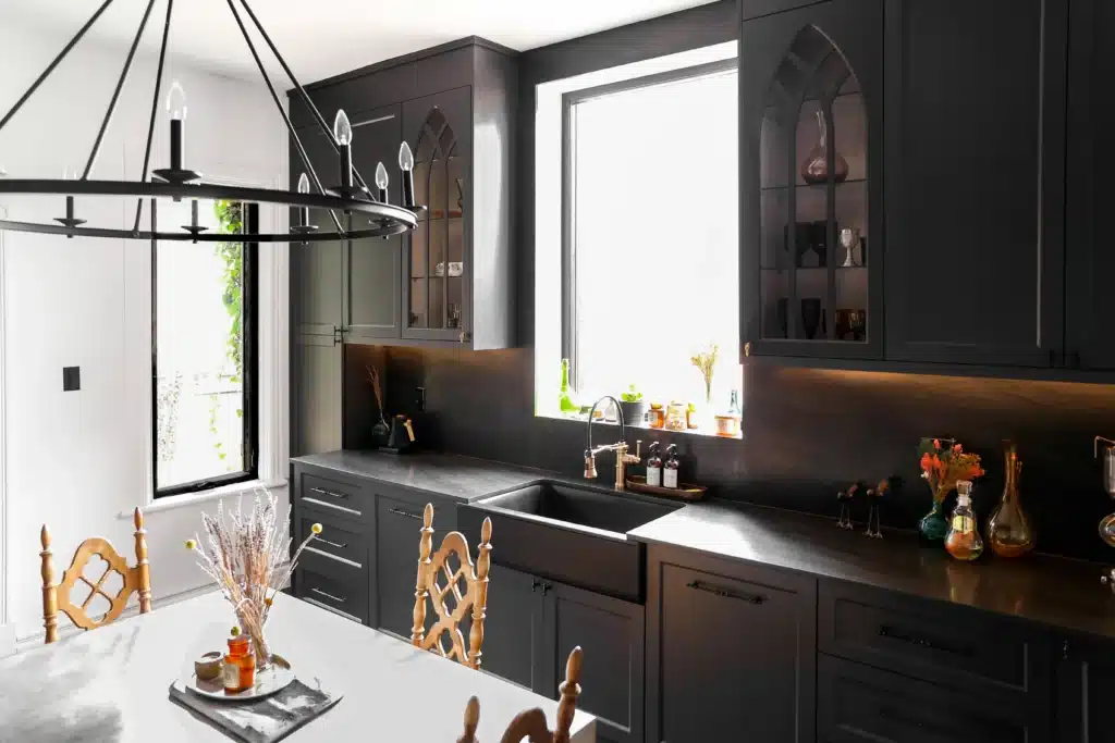 Victorian kitchen renovation in Toronto with dark custom cabinetry, farmhouse sink, and brass fixtures