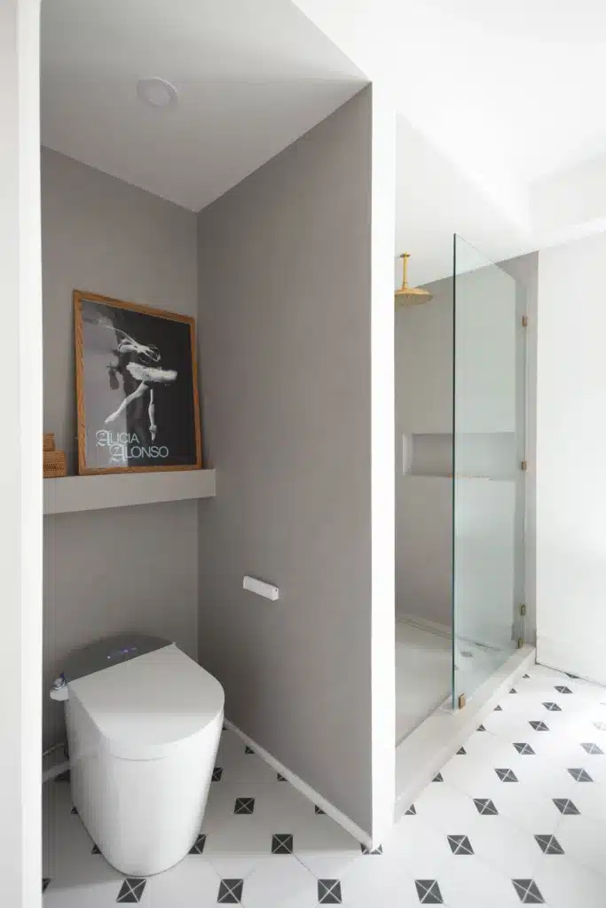 Modern bathroom renovation in Toronto Victorian home with glass shower, patterned tile floor, and smart toilet