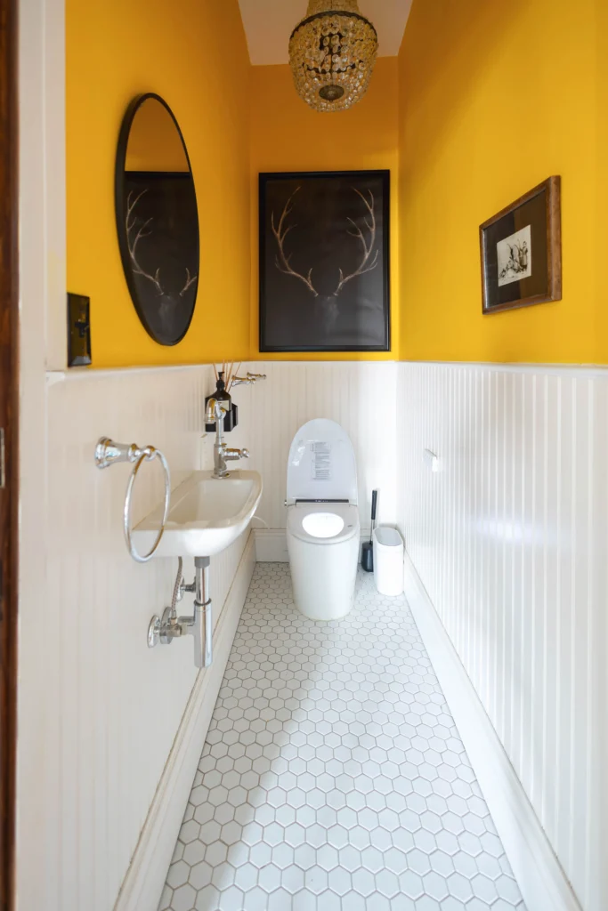 Victorian home powder room renovation in Toronto with smart toilet and yellow wall