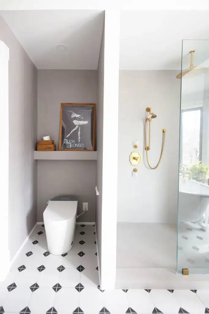 Modern bathroom renovation in Toronto Victorian home with glass shower, patterned tile floor, modern soakin tub with a smart toilet